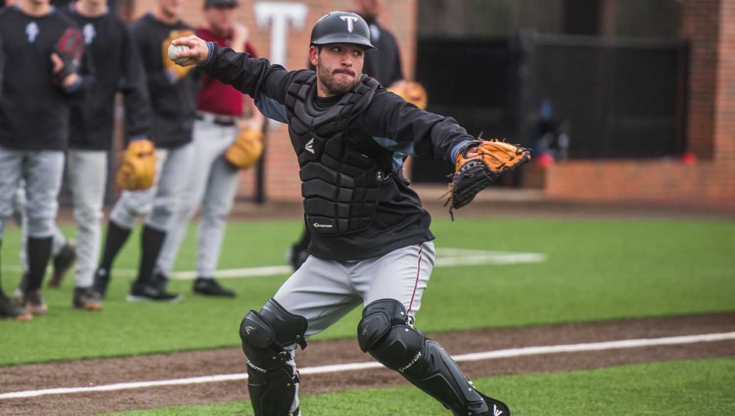 Photo/Jonah enfinger Chase Smartt throws comes out of the crouch as Troy’s catcher on day one of spring practice on Friday afternoon. The Trojans will open up the 2017 season on February 18 against Xavier. 