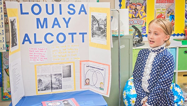 Messenger photo/Jonah Enfinger Students at Covenant Christian School brought history to life on Friday with a wax museum presentation. Above, Penelope Earnest learned about Louisa May Alcott.